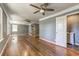 Spacious living room with hardwood floors, stone fireplace, and modern fan at 1472 Norman Berry Dr, Atlanta, GA 30344