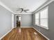 Living room with hardwood floors, ceiling fan, and access to the kitchen at 1472 Norman Berry Dr, Atlanta, GA 30344