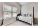 Bedroom features a four poster bed with patterned bedding, plush carpeting, and bright window at 204 Stone Creek Ct, Temple, GA 30179