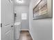 Bright laundry room with washer, dryer, wood-look floors, and neutral paint color at 204 Stone Creek Ct, Temple, GA 30179