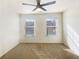 Bright bedroom with neutral walls, plush carpet, and natural light from two windows at 2693 Avanti Way, Decatur, GA 30035