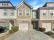 Charming townhome featuring a stone facade, attached garage, and well-maintained landscaping at 2693 Avanti Way, Decatur, GA 30035