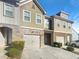 Attractive townhome featuring a stone facade, attached garage, and manicured landscaping at 2693 Avanti Way, Decatur, GA 30035