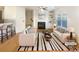 Bright living room featuring hardwood floors, fireplace, and a ceiling fan, staged with modern furniture at 2693 Avanti Way, Decatur, GA 30035