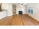Spacious living room with hardwood floors, a cozy fireplace, and natural light from large windows at 2693 Avanti Way, Decatur, GA 30035
