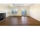 Open living room with hardwood floors, a fireplace, and double doors leading to the backyard at 2693 Avanti Way, Decatur, GA 30035