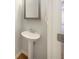 Charming powder room featuring a pedestal sink, framed mirror, and modern fixtures at 2693 Avanti Way, Decatur, GA 30035