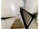 Carpeted staircase with dark wood railing provides access to the upper level at 2693 Avanti Way, Decatur, GA 30035