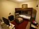 Bedroom featuring a bunk bed, comfortable chair, and workspace at 2726 Evans Mill Dr, Lithonia, GA 30058