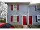 This charming townhome has blue siding, red shutters, and a bright red front door at 2726 Evans Mill Dr, Lithonia, GA 30058
