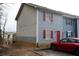 View of townhouse featuring light blue siding and red door with small front yard at 2726 Evans Mill Dr, Lithonia, GA 30058