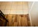 Transition from laminate to tiled floors at the base of a staircase at 2726 Evans Mill Dr, Lithonia, GA 30058