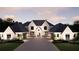 Elegant exterior view of a two-story home showcasing its symmetrical design, stone entrance, and lush landscaping at 4428 Blackland Dr, Marietta, GA 30067