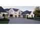 Charming two-story home featuring a stone arch entry, black trim windows, and a spacious three-car garage at 4428 Blackland Dr, Marietta, GA 30067