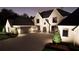 Striking home exterior with elegant stone accents, lush landscaping, ample parking, and a welcoming three-car garage at 4428 Blackland Dr, Marietta, GA 30067
