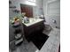 Bathroom featuring a dark wood vanity, natural light, and modern fixtures on white tile floor at 724 Camelot Way, Norcross, GA 30071