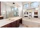 Bright bathroom features a soaking tub, a separate shower, vanity and large mirror at 211 Congress Pkwy, Lawrenceville, GA 30044