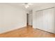 This bedroom features gleaming hardwood floors, a ceiling fan and a spacious closet at 211 Congress Pkwy, Lawrenceville, GA 30044