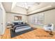This bedroom offers a tray ceiling, ceiling fan and hardwood flooring at 211 Congress Pkwy, Lawrenceville, GA 30044