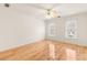 This spacious bedroom has two windows, a ceiling fan, and hardwood flooring at 211 Congress Pkwy, Lawrenceville, GA 30044