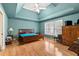 Spacious bedroom with a tray ceiling, ceiling fan, and hardwood flooring at 211 Congress Pkwy, Lawrenceville, GA 30044