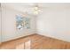 This bedroom has a ceiling fan, one window, and hardwood flooring at 211 Congress Pkwy, Lawrenceville, GA 30044