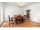 Formal dining room with hardwood floors and a classic chandelier, perfect for Gathering meals at 211 Congress Pkwy, Lawrenceville, GA 30044