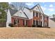Side view of a brick two-story home with black shutters showcasing a well-maintained exterior at 211 Congress Pkwy, Lawrenceville, GA 30044