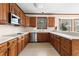 Traditional kitchen with wooden cabinets and a functional layout, ready for culinary adventures at 211 Congress Pkwy, Lawrenceville, GA 30044