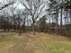Expansive backyard space with mature trees offering privacy and natural beauty at 5862 Kitchens Se Rd, Mableton, GA 30126