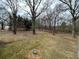 Large, grassy backyard features scattered trees and a serene, natural setting at 5862 Kitchens Se Rd, Mableton, GA 30126