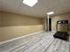 Finished basement with vinyl flooring, a half wall and a treadmill at 5862 Kitchens Se Rd, Mableton, GA 30126