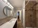 Bathroom showcasing tiled shower, granite countertops and modern fixtures at 5862 Kitchens Se Rd, Mableton, GA 30126
