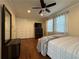 Bedroom with hardwood floors, ceiling fan, closet, and natural light at 5862 Kitchens Se Rd, Mableton, GA 30126