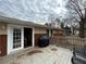 Exterior home view from the deck shows a patio entrance and wooded area nearby at 5862 Kitchens Se Rd, Mableton, GA 30126