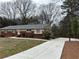 View of the home with newly poured concrete driveway at 5862 Kitchens Se Rd, Mableton, GA 30126
