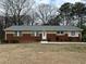 Charming ranch-style home featuring a brick facade and well-manicured landscaping at 5862 Kitchens Se Rd, Mableton, GA 30126
