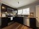 Kitchen showcasing stainless steel appliances, granite counters, and dark wood cabinetry at 5862 Kitchens Se Rd, Mableton, GA 30126