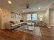 Spacious living room featuring a large sectional sofa, hardwood floors, and a ceiling fan at 5862 Kitchens Se Rd, Mableton, GA 30126