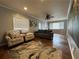 Cozy living room features beautiful hardwood floors, ceiling fan, and natural light from multiple windows at 5862 Kitchens Se Rd, Mableton, GA 30126
