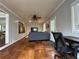 Open living room showcases hardwood floors, ceiling fan, and access to work area at 5862 Kitchens Se Rd, Mableton, GA 30126