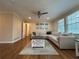 Comfortable living room features large sectional sofa and hardwood floors at 5862 Kitchens Se Rd, Mableton, GA 30126