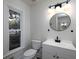 Modern half bath featuring updated fixtures, a sleek vanity, and natural light from a large window at 742 Olde Towne Ln, Marietta, GA 30068