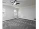 Bright bedroom with neutral carpet, a ceiling fan, and windows for ample natural light at 742 Olde Towne Ln, Marietta, GA 30068