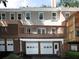 Back view of townhomes with decks above attached garages at 742 Olde Towne Ln, Marietta, GA 30068