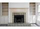 Cozy living room featuring a classic fireplace with tiled surround and built-in shelving at 742 Olde Towne Ln, Marietta, GA 30068