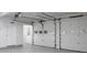 Spacious garage with white doors, windows, and a gray epoxy floor at 742 Olde Towne Ln, Marietta, GA 30068