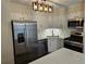 Modern kitchen with stainless steel appliances, sleek white cabinets, and quartz countertops at 742 Olde Towne Ln, Marietta, GA 30068