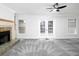 Bright living room with fireplace, plush carpet, and French doors leading to outdoor space at 742 Olde Towne Ln, Marietta, GA 30068