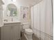Cozy bathroom featuring a neutral-colored vanity and a shower with a curtain at 10594 Serenbe Ln, Chattahoochee Hills, GA 30268